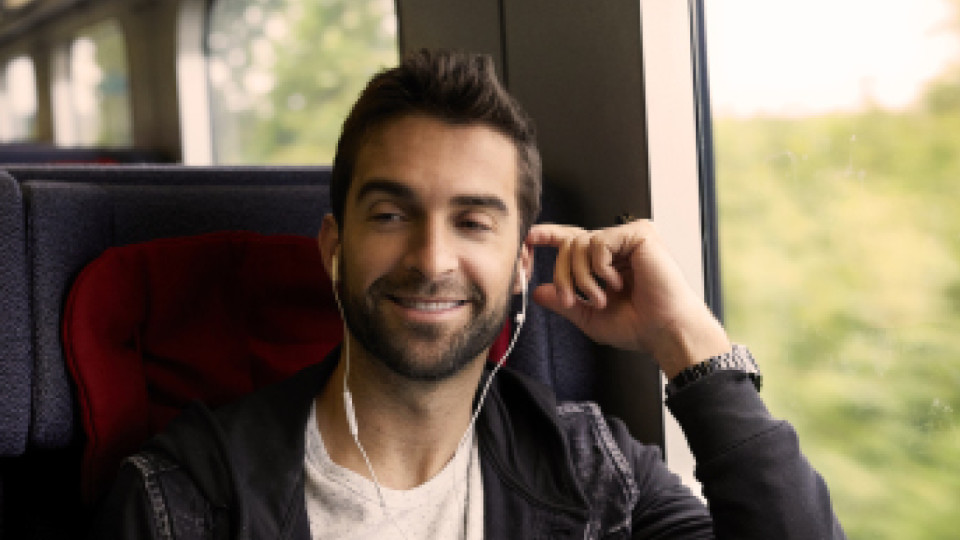 Man on train with headphones in
