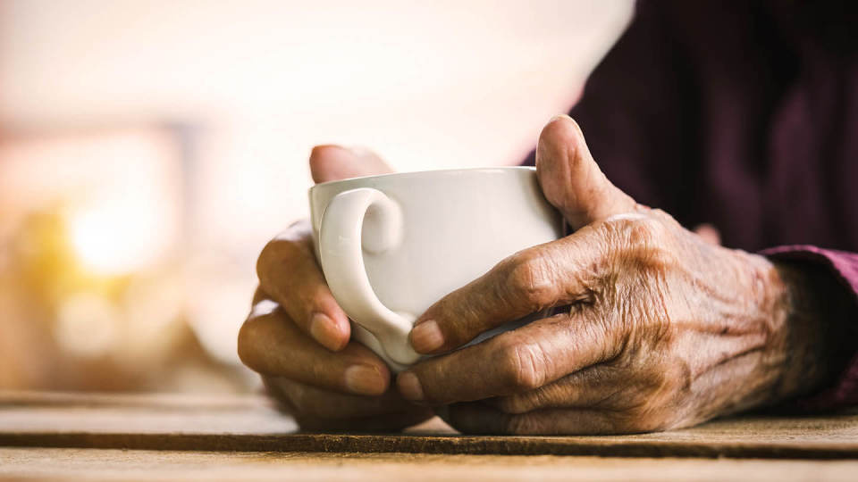Newsroom - elderly hands holding cup of tea