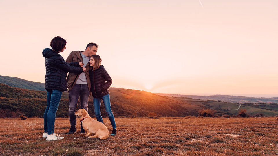 Family with dog on a hill