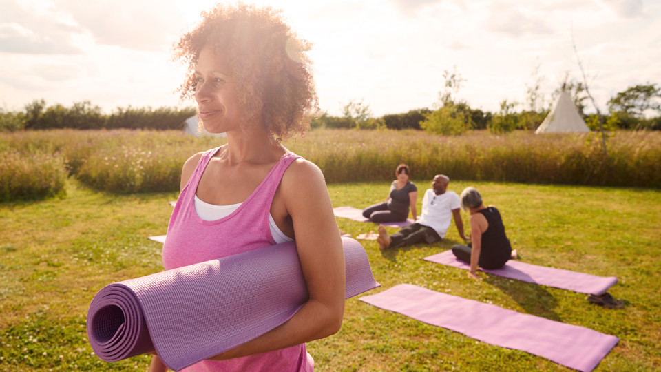 Woman in pink with yoga mat